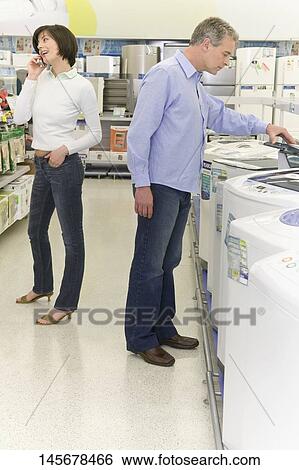 Stock Photograph - Couple in a supermarket. Fotosearch