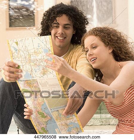 Couple looking at a map and smiling, Biltmore Hotel, Coral Gables, Florida, USA View Large Photo Image Stock Photo - Couple looking at a map and smiling, Biltmore Hotel, Coral Gables, Florida, USA. Fotosearch