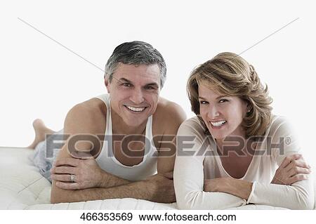 Couple lying on the bed and smiling View Large Photo Image Stock Photo - Couple lying on the bed and smiling. Fotosearch