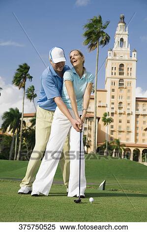 Stock Photography - Couple playing golf, Biltmore Golf Course, Biltmore Hotel, Florida, USA. Fotosearch