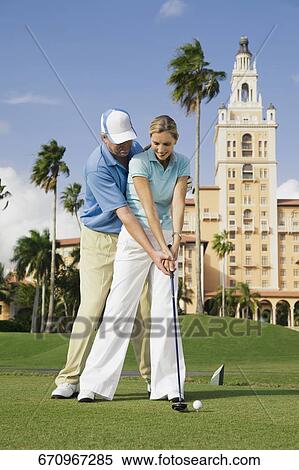 Couple playing golf, Biltmore Golf Course, Biltmore Hotel, Florida, USA View Large Photo Image Stock Photography - Couple playing golf, Biltmore Golf Course, Biltmore Hotel, Florida, USA. Fotosearch