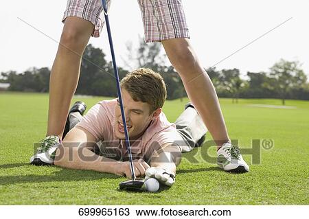 Stock Image - Couple playing golf in a golf course, Biltmore Golf Course, Coral Gables, Florida, USA. Fotosearch