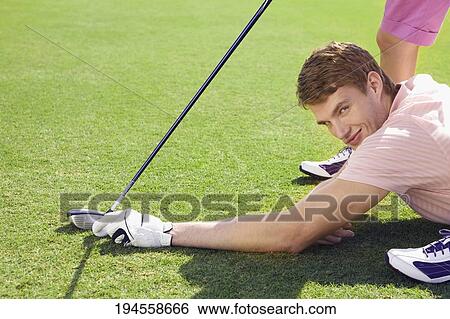 Stock Photograph - Couple playing golf in a golf course, Biltmore Golf Course, Coral Gables, Florida, USA. Fotosearch
