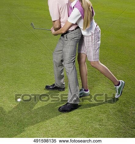 Couple playing golf in a golf course, Biltmore Golf Course, Coral Gables, Florida, USA View Large Photo Image Stock Photography - Couple playing golf in a golf course, Biltmore Golf Course, Coral Gables, Florida, USA. Fotosearch