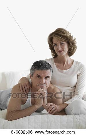 Stock Photograph - Couple relaxing on the bed. Fotosearch