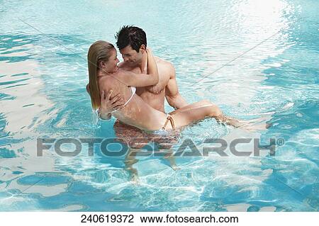 Couple romancing in a swimming pool, Biltmore Hotel, Coral Gables, Florida, USA View Large Photo Image Stock Image - Couple romancing in a swimming pool, Biltmore Hotel, Coral Gables, Florida, USA. Fotosearch
