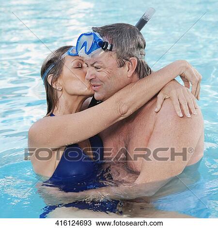 Stock Image - Couple romancing in a swimming pool, Biltmore Hotel, Coral Gables, Florida, USA. Fotosearch