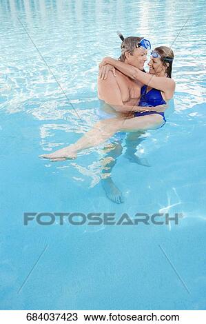 Couple romancing in a swimming pool, Biltmore Hotel, Coral Gables, Florida, USA View Large Photo Image Stock Image - Couple romancing in a swimming pool, Biltmore Hotel, Coral Gables, Florida, USA. Fotosearch