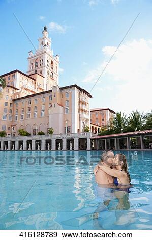 Couple romancing in a swimming pool, Biltmore Hotel, Coral Gables, Florida, USA View Large Photo Image Stock Photo - Couple romancing in a swimming pool, Biltmore Hotel, Coral Gables, Florida, USA. Fotosearch