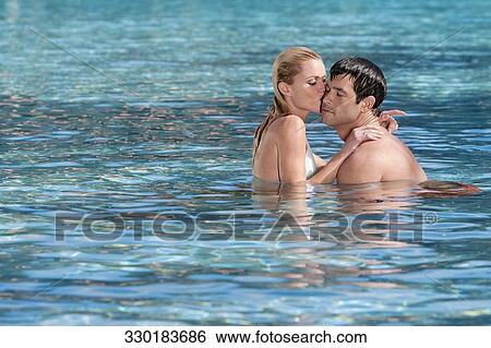 Couple romancing in a swimming pool, Biltmore Hotel, Coral Gables, Florida, USA View Large Photo Image Stock Photograph - Couple romancing in a swimming pool, Biltmore Hotel, Coral Gables, Florida, USA. Fotosearch