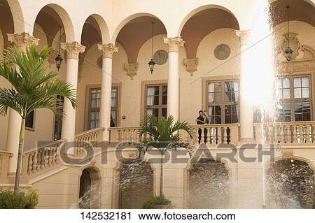 Stock Image - Couple romancing in the balcony, Biltmore Hotel, Coral Gables, Florida, USA. Fotosearch