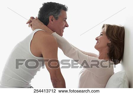 Stock Image - Couple romancing in the bedroom. Fotosearch