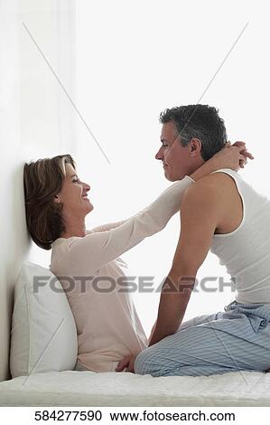 Couple romancing in the bedroom View Large Photo Image Stock Image - Couple romancing in the bedroom. Fotosearch