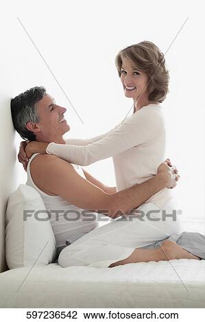 Couple romancing in the bedroom View Large Photo Image Stock Image - Couple romancing in the bedroom. Fotosearch