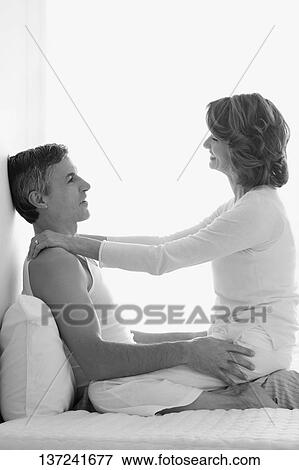 Couple romancing in the bedroom View Large Photo Image Stock Photo - Couple romancing in the bedroom. Fotosearch