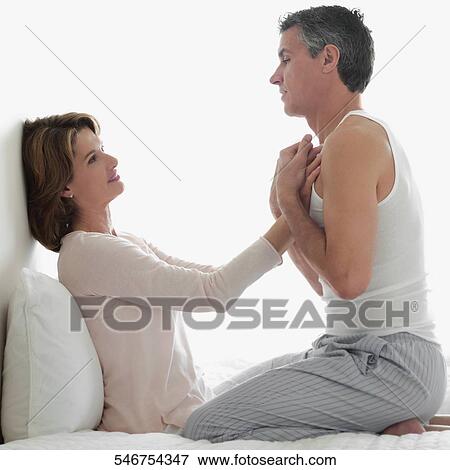 Stock Photo - Couple romancing in the bedroom. Fotosearch
