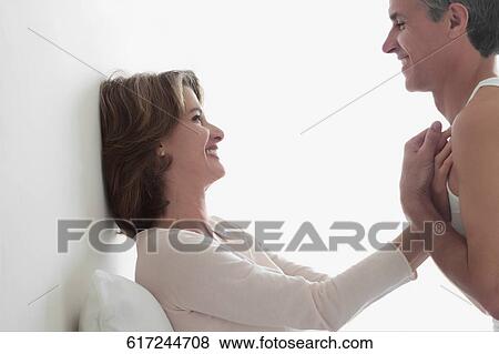 Couple romancing in the bedroom View Large Photo Image Stock Photo - Couple romancing in the bedroom. Fotosearch