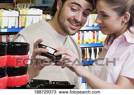 Stock Image - Couple shopping in a supermarket. Fotosearch
