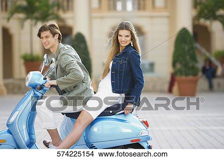Couple sitting on a moped, Biltmore Hotel, Coral Gables, Florida, USA View Large Photo Image Picture - Couple sitting on a moped, Biltmore Hotel, Coral Gables, Florida, USA. Fotosearch