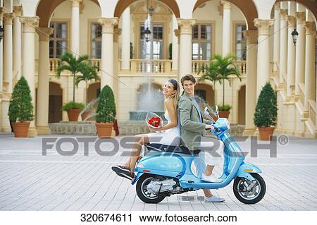 Couple sitting on a moped, Biltmore Hotel, Coral Gables, Florida, USA View Large Photo Image Stock Image - Couple sitting on a moped, Biltmore Hotel, Coral Gables, Florida, USA. Fotosearch
