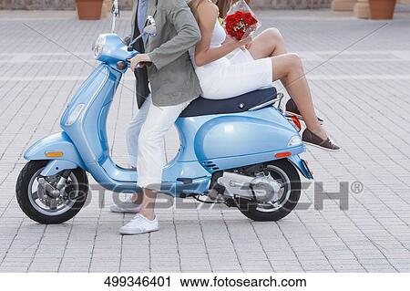 Couple sitting on a moped, Biltmore Hotel, Coral Gables, Florida, USA View Large Photo Image Stock Image - Couple sitting on a moped, Biltmore Hotel, Coral Gables, Florida, USA. Fotosearch