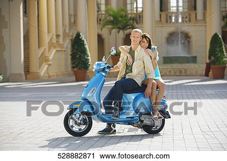 Couple sitting on a moped, Biltmore Hotel, Coral Gables, Florida, USA View Large Photo Image Stock Image - Couple sitting on a moped, Biltmore Hotel, Coral Gables, Florida, USA. Fotosearch