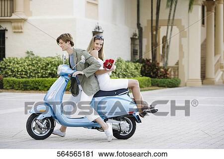 Couple sitting on a moped, Biltmore Hotel, Coral Gables, Florida, USA View Large Photo Image Stock Image - Couple sitting on a moped, Biltmore Hotel, Coral Gables, Florida, USA. Fotosearch