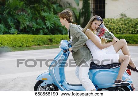 Couple sitting on a moped, Biltmore Hotel, Coral Gables, Florida, USA View Large Photo Image Stock Image - Couple sitting on a moped, Biltmore Hotel, Coral Gables, Florida, USA. Fotosearch