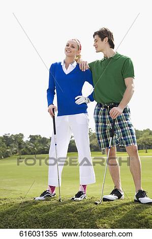 Stock Photography - Couple standing in a golf course, Biltmore Golf Course, Coral Gables, Florida, USA. Fotosearch