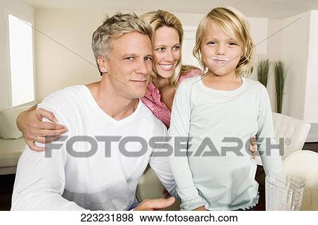 Couple with their daughter smiling View Large Photo Image Stock Photo - Couple with their daughter smiling. Fotosearch