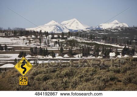 Stock Photo - Curve in road sign with mountains in the background, Norris, Madison County, Montana, USA. Fotosearch