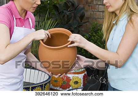 Customer buying a decorative urn View Large Photo Image Stock Image - Customer buying a decorative urn. Fotosearch