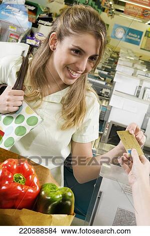 Picture - Customer giving a credit card to cashier. Fotosearch