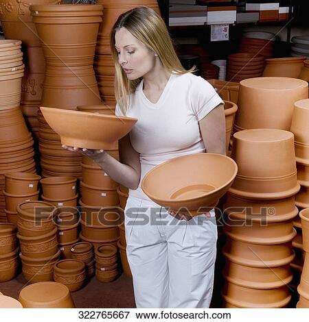 Customer holding earthenware View Large Photo Image Stock Photo - Customer holding earthenware. Fotosearch