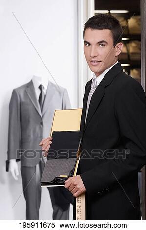 Customer holding fabric swatches in a clothing store View Large Photo Image Stock Photography - Customer holding fabric swatches in a clothing store. Fotosearch