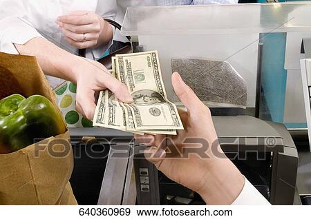 Stock Photo - Customer paying at the checkout counter. Fotosearch