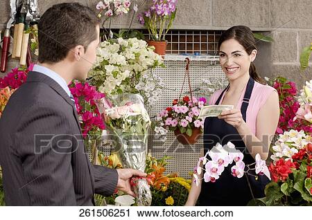 Customer purchasing a bouquet of flowers View Large Photo Image Stock Image - Customer purchasing a bouquet of flowers. Fotosearch