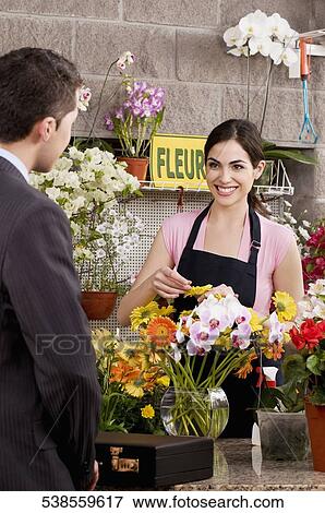 Customer purchasing a bouquet of flowers View Large Photo Image Stock Photo - Customer purchasing a bouquet of flowers. Fotosearch