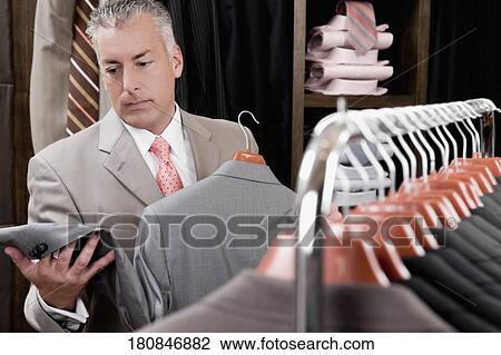 Customer shopping in a clothing store View Large Photo Image Stock Image - Customer shopping in a clothing store. Fotosearch