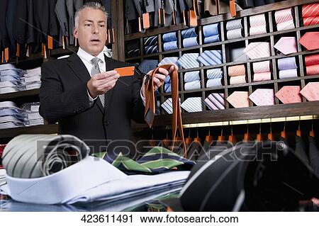 Customer shopping in a clothing store View Large Photo Image Stock Image - Customer shopping in a clothing store. Fotosearch