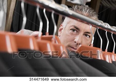 Stock Photo - Customer shopping in a clothing store. Fotosearch