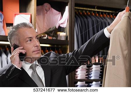 Customer shopping in a clothing store View Large Photo Image Stock Photo - Customer shopping in a clothing store. Fotosearch