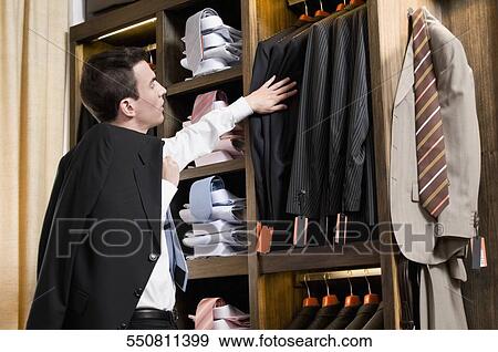 Customer shopping in a clothing store View Large Photo Image Stock Photo - Customer shopping in a clothing store. Fotosearch