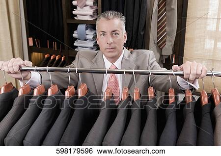 Customer shopping in a clothing store View Large Photo Image Stock Photograph - Customer shopping in a clothing store. Fotosearch