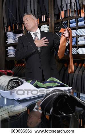 Customer shopping in a clothing store View Large Photo Image Stock Photography - Customer shopping in a clothing store. Fotosearch