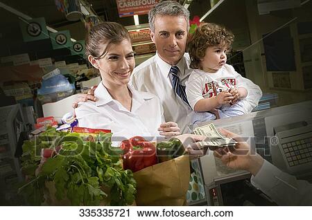 Customers making payments at the checkout counter View Large Photo Image Stock Image - Customers making payments at the checkout counter. Fotosearch