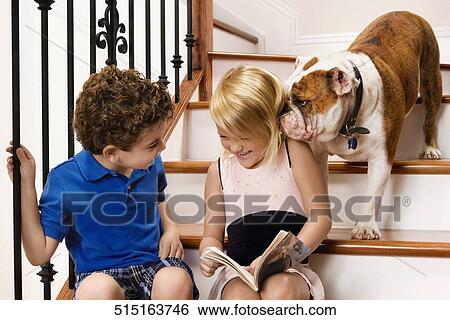Dog licking the ear of a girl View Large Photo Image Stock Photograph - Dog licking the ear of a girl. Fotosearch