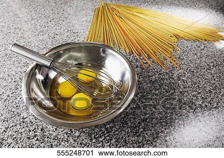 Egg yolk and an egg beater in a bowl with spaghetti View Large Photo Image Stock Image - Egg yolk and an egg beater in a bowl with spaghetti. Fotosearch