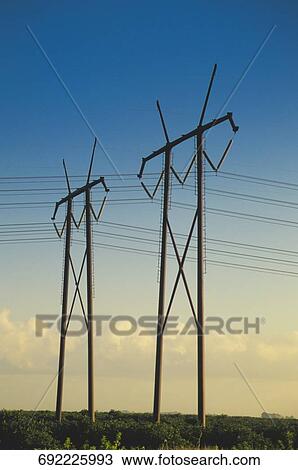 Stock Image - Electricity pylons against the blue sky. Fotosearch