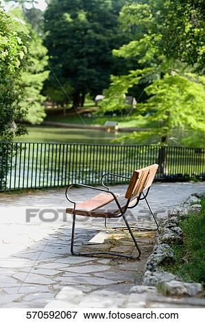 Empty bench in a park, Madrid, Spain View Large Photo Image Stock Photo - Empty bench in a park, Madrid, Spain. Fotosearch